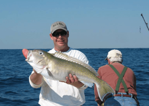 Angler holding up tilefish caught jigging at a wreck.