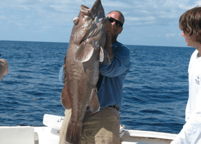 One charter angler showing off a massive Grouper caught on Open Waters off Hatteras, NC.